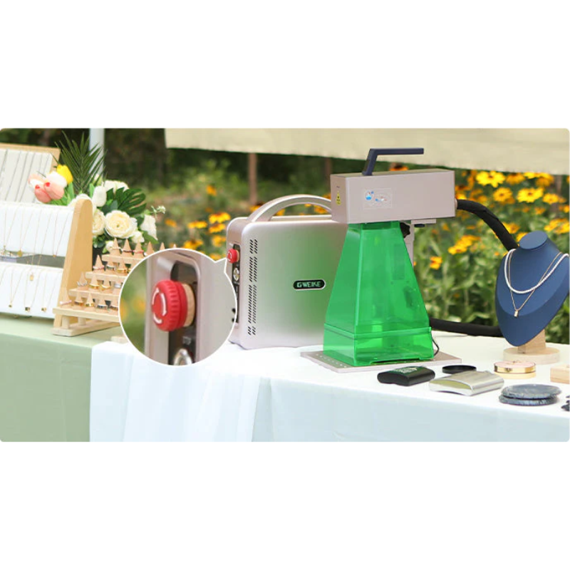 gweike g2 max fibre laser engraver with transparent green safety shield featuring a stop rotary dial at an outdoor event