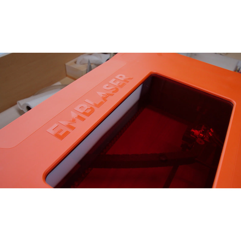 high angle view of emblaser pro laser cutter with a red transparent viewing window on the top cover