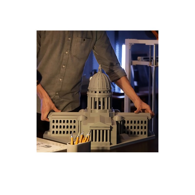 man holding stone grey building model created by elegoo orangestorm giga 3d printer