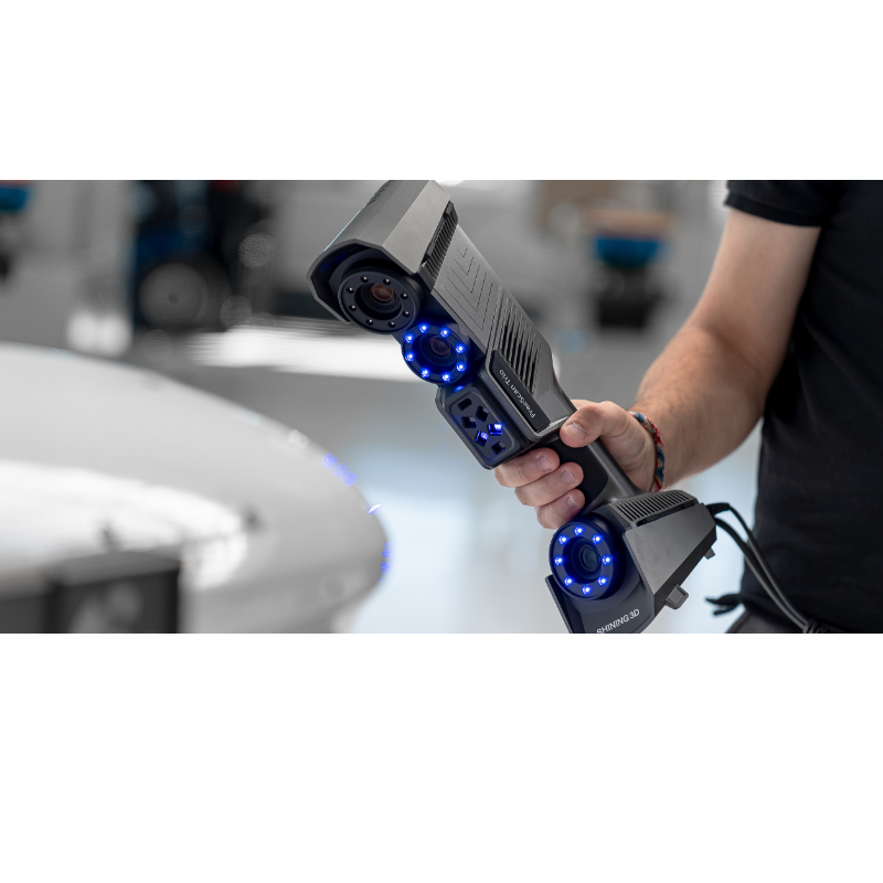 freescan trio laser 3d scanner with blue lights held diagonally from front right side view