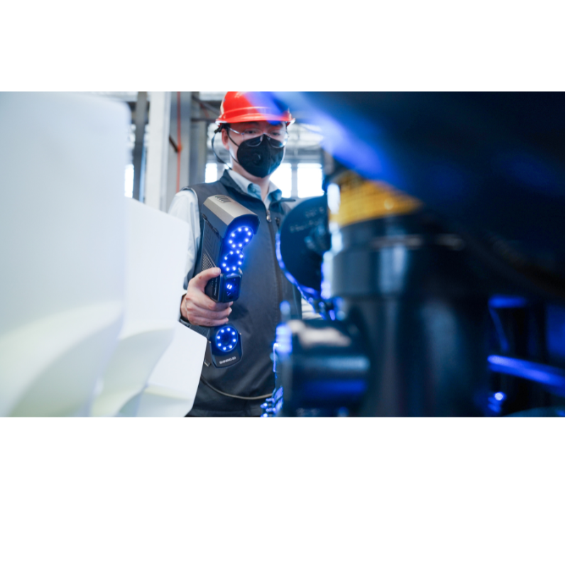 freescan trio laser 3d scanner in use by a man wearing a construction helmet to scan metal object 