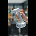 hand holding a shining 3d einscan h2 scanner  with a blurred background