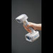 hand holding a shining 3d einscan h2 scanner with a plain grey background