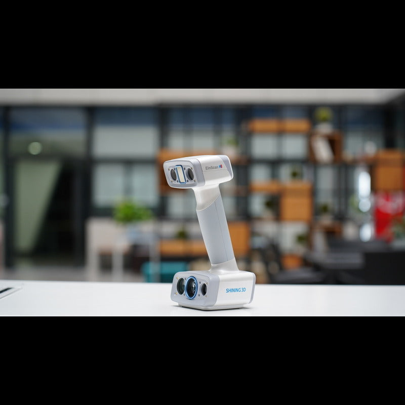 shining 3d einscan h2 scanner on a white table with a blurred back ground from a front right side view