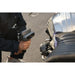 a person is holding a shining 3d einscan rigil to scan the seat and fuel tank of light grey motorcycle