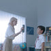 female teacher scans a young male student with a shining 3d einstar scanner in a classroom