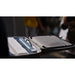 shining 3d einstar hand held scanner positioned with a white rectangular box inside a hard shell carrying case in a blurred background