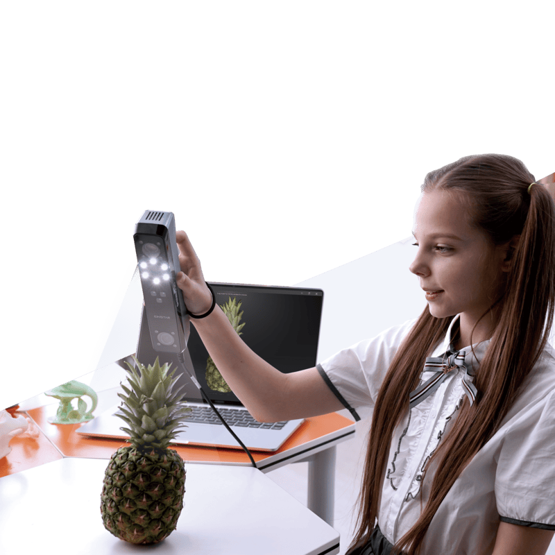 young girl scans a pineapple on the table using a shining 3d einstar scanner with a laptop displaying data output besides her