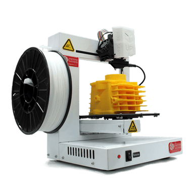 tiertime up plus 2 3d printer from a front left side view showing a yellow 3d printed object on the platform