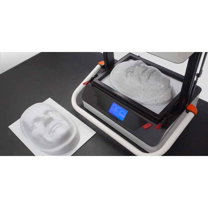 high angle view of vaquform dt2 digital desktop vacuum former machine in operation producing masks