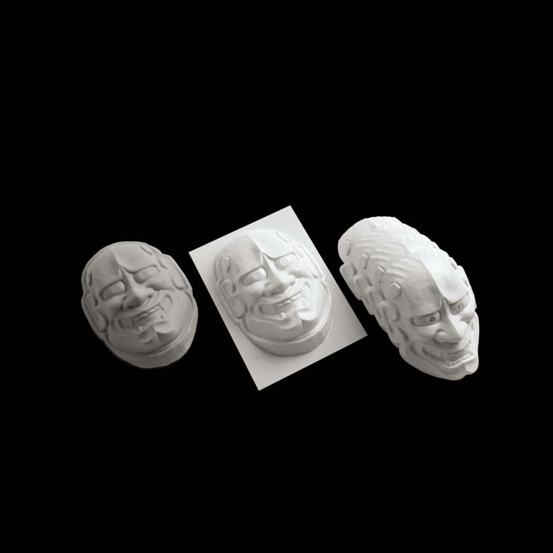 high angle view of masks created using the vaquform dt2 digital desktop vacuum former machine on a black background